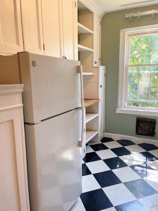 85 N Broadway Unit 2H, White Plains, NY 10603 - kitchen with freestanding refrigerator, open shelves, tile patterned floors, and white cabinetry