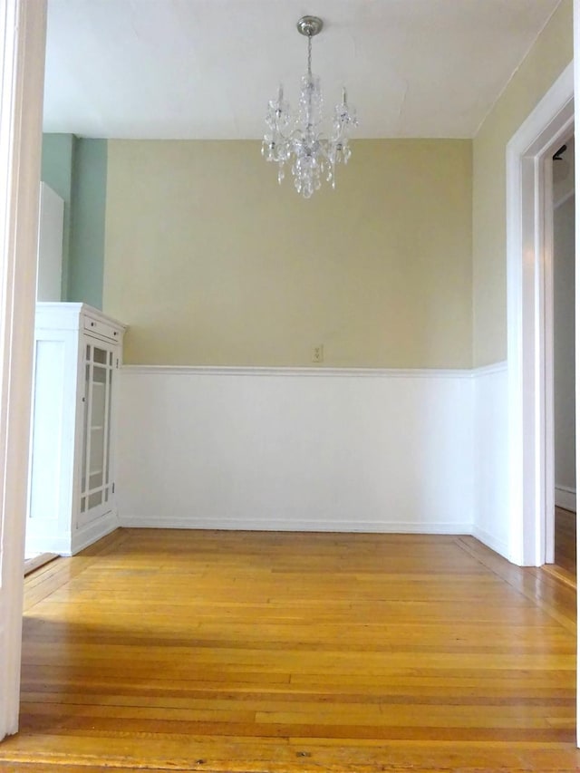 85 N Broadway Unit 2H, White Plains, NY 10603 - unfurnished room with a chandelier and light wood-type flooring