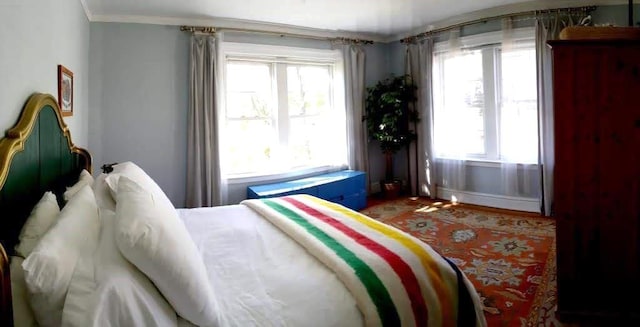 85 N Broadway Unit 2H, White Plains, NY 10603 - bedroom with multiple windows, crown molding, and wood finished floors