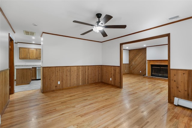 920 Mount Vernon Rd, Wurtsboro, NY 12790 - unfurnished living room with a wainscoted wall, wooden walls, light wood-type flooring, a ceiling fan, and a glass covered fireplace