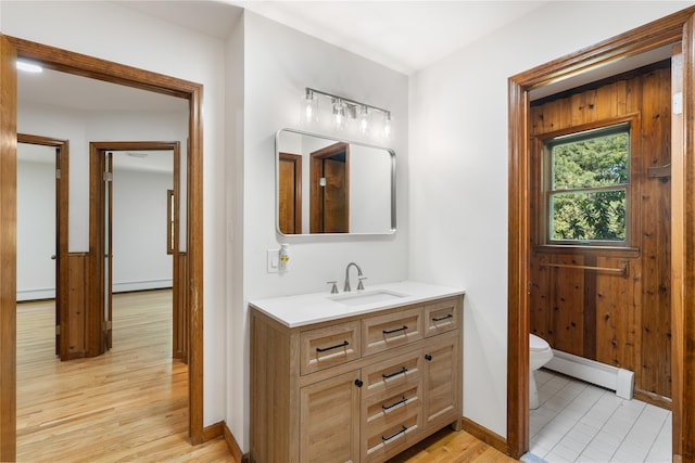 920 Mount Vernon Rd, Wurtsboro, NY 12790 - bathroom featuring a baseboard radiator, vanity, rail lighting, baseboard heating, and wood finished floors