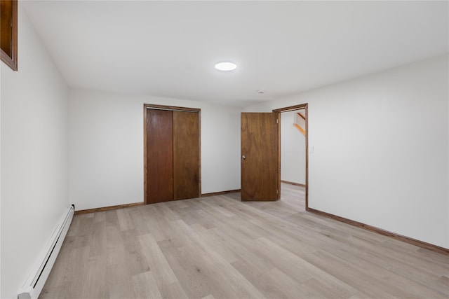 920 Mount Vernon Rd, Wurtsboro, NY 12790 - unfurnished bedroom with baseboard heating, a closet, and light wood-type flooring