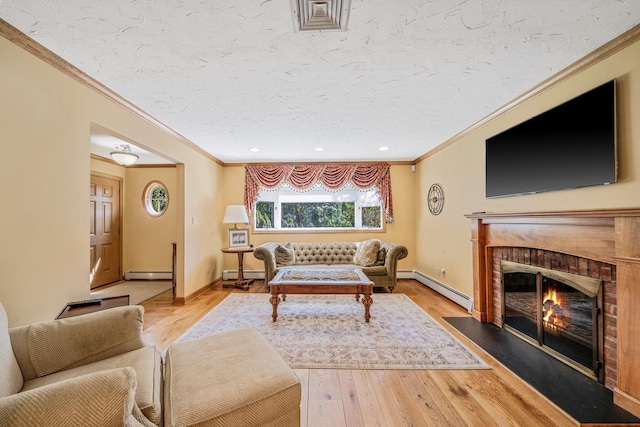 7 Hunter Ct, Dix Hills, NY 11746 - living area with crown molding, baseboard heating, a baseboard radiator, a fireplace, and light wood-style floors