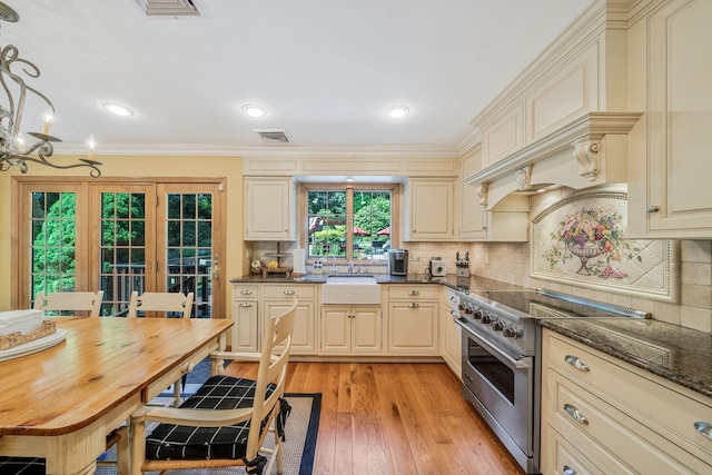 7 Hunter Ct, Dix Hills, NY 11746 - kitchen featuring high end range, cream cabinetry, ornamental molding, light wood-style flooring, and tasteful backsplash