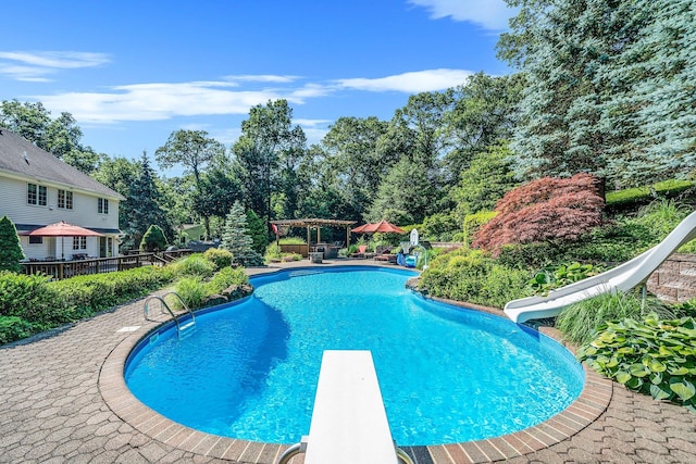 7 Hunter Ct, Dix Hills, NY 11746 - outdoor pool featuring a water slide, a diving board, a deck, and view of scattered trees