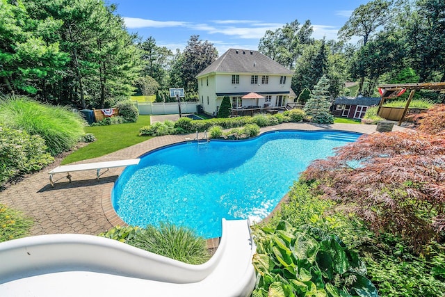 7 Hunter Ct, Dix Hills, NY 11746 - view of swimming pool with an outdoor structure, a fenced backyard, view of scattered trees, and a diving board