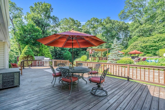 7 Hunter Ct, Dix Hills, NY 11746 - wooden terrace featuring outdoor dining space, view of wooded area, and area for grilling