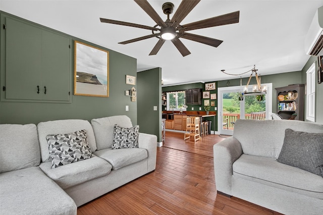 54 Graby Rd, Callicoon, NY 12723 - living area with ceiling fan, a wall unit AC, wood finished floors, and a chandelier