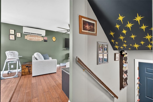 54 Graby Rd, Callicoon, NY 12723 - corridor featuring an AC wall unit, wood finished floors, an upstairs landing, a baseboard heating unit, and lofted ceiling