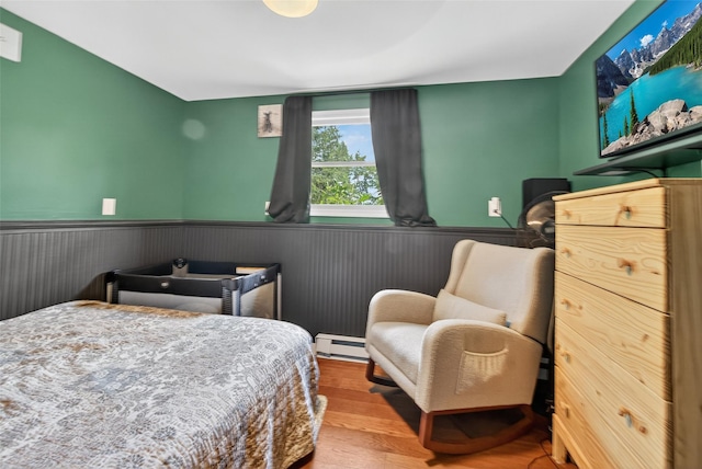 54 Graby Rd, Callicoon, NY 12723 - bedroom with a wainscoted wall, wood finished floors, and baseboard heating