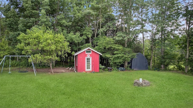 54 Graby Rd, Callicoon, NY 12723 - view of grassy yard with a storage unit, a playground, and a fire pit