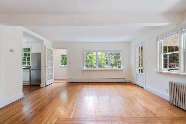1459 N Country Rd, Wading River, NY 11792 - empty room with baseboard heating, radiator heating unit, and wood-type flooring