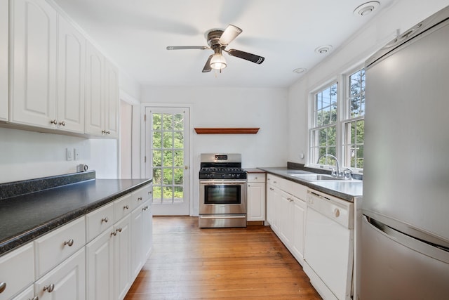 1459 N Country Rd, Wading River, NY 11792 - kitchen with fridge, dishwasher, stainless steel gas range, and dark countertops