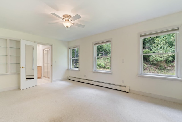 1459 N Country Rd, Wading River, NY 11792 - unfurnished bedroom featuring a baseboard heating unit, carpet, ensuite bath, and a ceiling fan