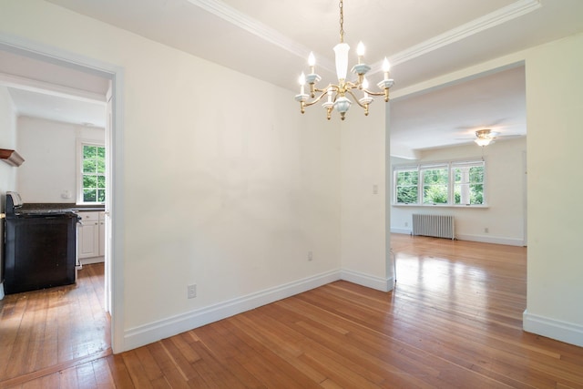 1459 N Country Rd, Wading River, NY 11792 - unfurnished dining area featuring radiator heating unit, a chandelier, wood-type flooring, and crown molding