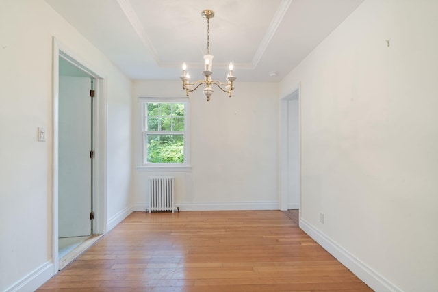 1459 N Country Rd, Wading River, NY 11792 - unfurnished dining area with radiator heating unit, a chandelier, light wood-style floors, a tray ceiling, and ornamental molding