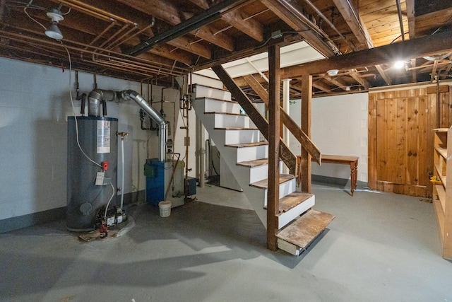 1459 N Country Rd, Wading River, NY 11792 - unfinished basement featuring gas water heater, stairs, concrete block wall, and a heating unit