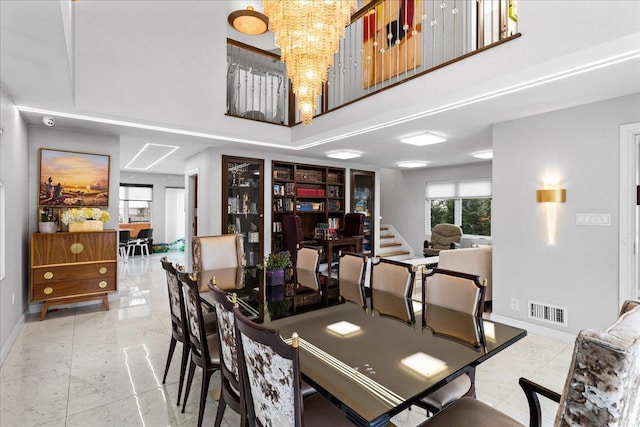 544 Oxford Rd, Cedarhurst, NY 11516 - dining space with a towering ceiling and a chandelier