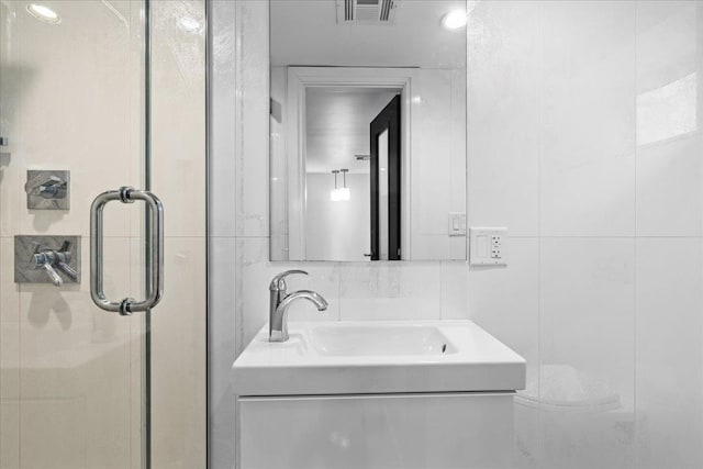 544 Oxford Rd, Cedarhurst, NY 11516 - full bathroom featuring vanity, a shower stall, and tile walls