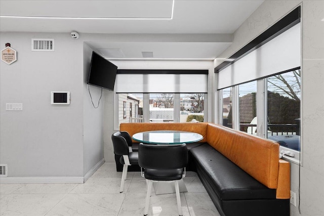 544 Oxford Rd, Cedarhurst, NY 11516 - dining room with marble look tile flooring and baseboards