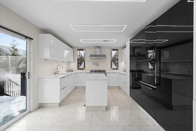 544 Oxford Rd, Cedarhurst, NY 11516 - kitchen with wall chimney range hood, modern cabinets, a kitchen island, and white cabinets