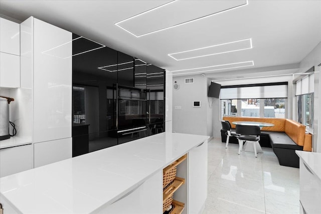 544 Oxford Rd, Cedarhurst, NY 11516 - kitchen featuring white cabinetry, modern cabinets, and light countertops