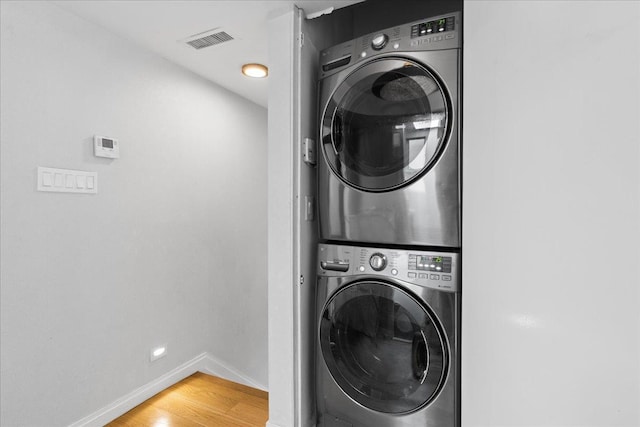 544 Oxford Rd, Cedarhurst, NY 11516 - laundry room featuring stacked washer / dryer and light wood-style flooring