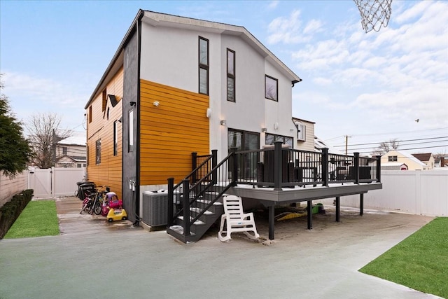 544 Oxford Rd, Cedarhurst, NY 11516 - rear view of property featuring a deck, a fenced backyard, a patio area, and a gate