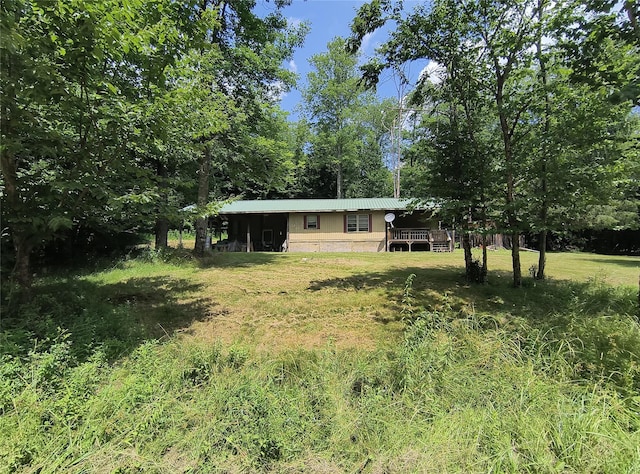 113 Lake Muskoday Rd, Roscoe, NY 12776 - view of front facade with a metal roof, a deck, and a front yard