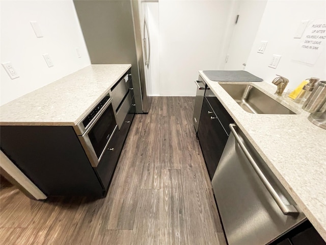 10 City Pl Unit Ph2C, White Plains, NY 10601 - kitchen featuring stainless steel dishwasher, dark cabinetry, and dark wood-style flooring