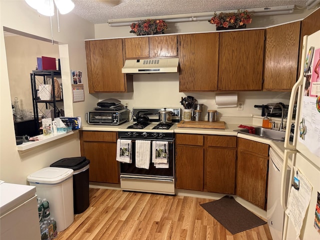 36 Huntington Cir, Peekskill, NY 10566 - kitchen with white appliances, custom exhaust hood, light countertops, brown cabinets, and a textured ceiling