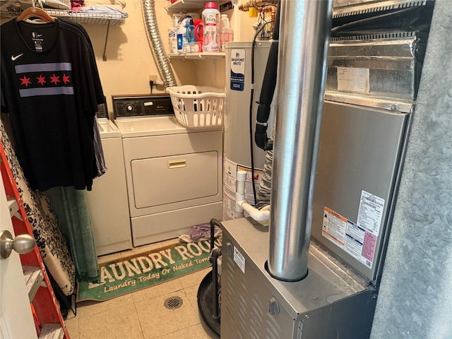 36 Huntington Cir, Peekskill, NY 10566 - washroom with washing machine and clothes dryer, light tile patterned floors, and gas water heater