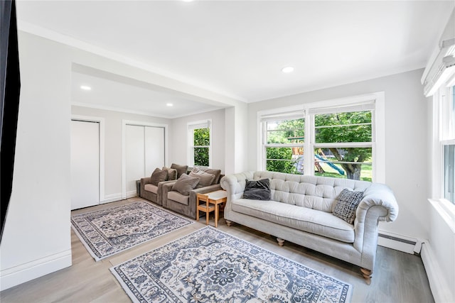63 Old Farm Rd, Levittown, NY 11756 - living area featuring wood finished floors, recessed lighting, a baseboard radiator, and crown molding