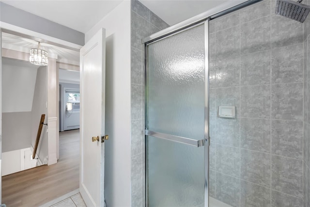 63 Old Farm Rd, Levittown, NY 11756 - bathroom with a tile shower, a chandelier, and wood finished floors