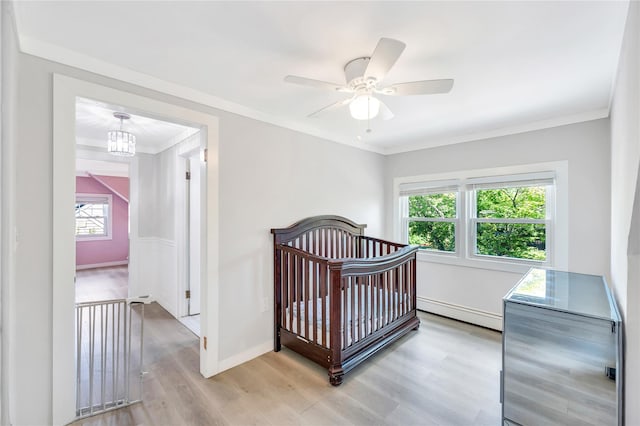 63 Old Farm Rd, Levittown, NY 11756 - bedroom featuring baseboard heating, light wood-type flooring, ornamental molding, ceiling fan, and a chandelier