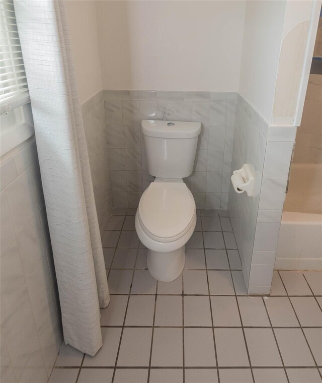 31 Peter Cooper Dr, Hyde Park, NY 12601 - bathroom featuring tile walls, a tub to relax in, tile patterned floors, wainscoting, and a shower with curtain