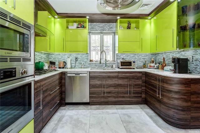 110-17 64th Ave, Forest Hills, NY 11375 - kitchen featuring stainless steel appliances, decorative backsplash, light stone counters, ventilation hood, and dark brown cabinets