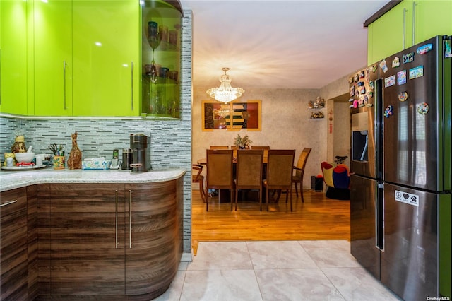 110-17 64th Ave, Forest Hills, NY 11375 - kitchen featuring stainless steel fridge, backsplash, a chandelier, light wood-style flooring, and light stone countertops