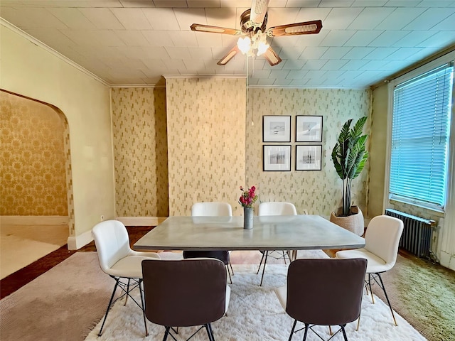7313 71st St, Ridgewood, NY 11385 - carpeted dining area with ornamental molding, ceiling fan, arched walkways, and wallpapered walls
