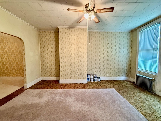 7313 71st St, Ridgewood, NY 11385 - carpeted spare room with ornamental molding, ceiling fan, and arched walkways