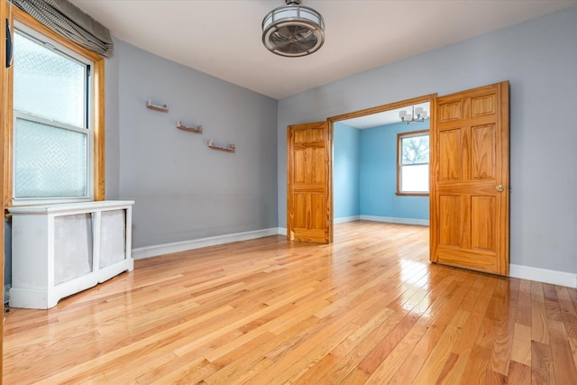 51-17 47th St Unit 2, Woodside, NY 11377 - spare room featuring light wood-style flooring and a chandelier