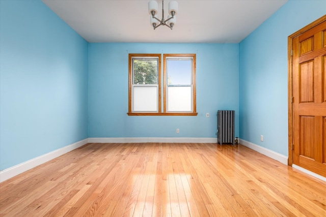 51-17 47th St Unit 2, Woodside, NY 11377 - unfurnished room with radiator heating unit, light wood-style flooring, and a chandelier