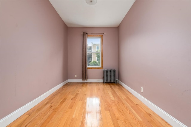 51-17 47th St Unit 2, Woodside, NY 11377 - unfurnished room with radiator heating unit and light wood-style floors