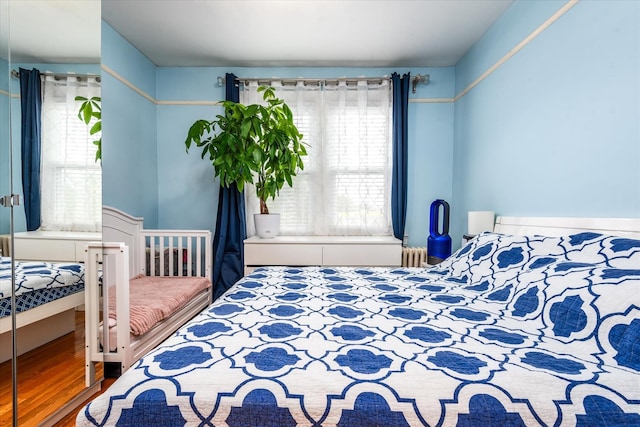 51-17 47th St Unit 2, Woodside, NY 11377 - bedroom featuring radiator heating unit and wood finished floors
