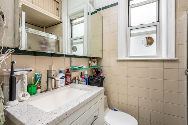 51-17 47th St Unit 2, Woodside, NY 11377 - full bathroom featuring tile walls, vanity, tasteful backsplash, and a stall shower