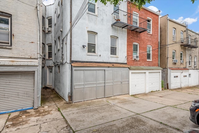 51-17 47th St Unit 2, Woodside, NY 11377 - view of building exterior featuring an attached garage and driveway