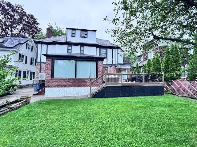 3345 160th St, Flushing, NY 11358 - back of property with a yard, brick siding, a wooden deck, a chimney, and stairs