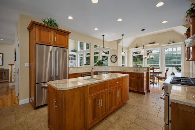 90 River Rd, Hyde Park, NY 12538 - kitchen featuring stainless steel appliances, brown cabinetry, healthy amount of natural light, light stone counters, and recessed lighting