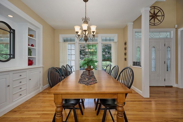 90 River Rd, Hyde Park, NY 12538 - dining room with light wood-type flooring, a chandelier, and built in shelves