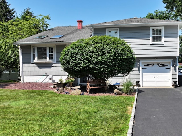 114 Shetland Dr, New City, NY 10956 - view of front of home with a garage, a front lawn, driveway, a shingled roof, and a chimney
